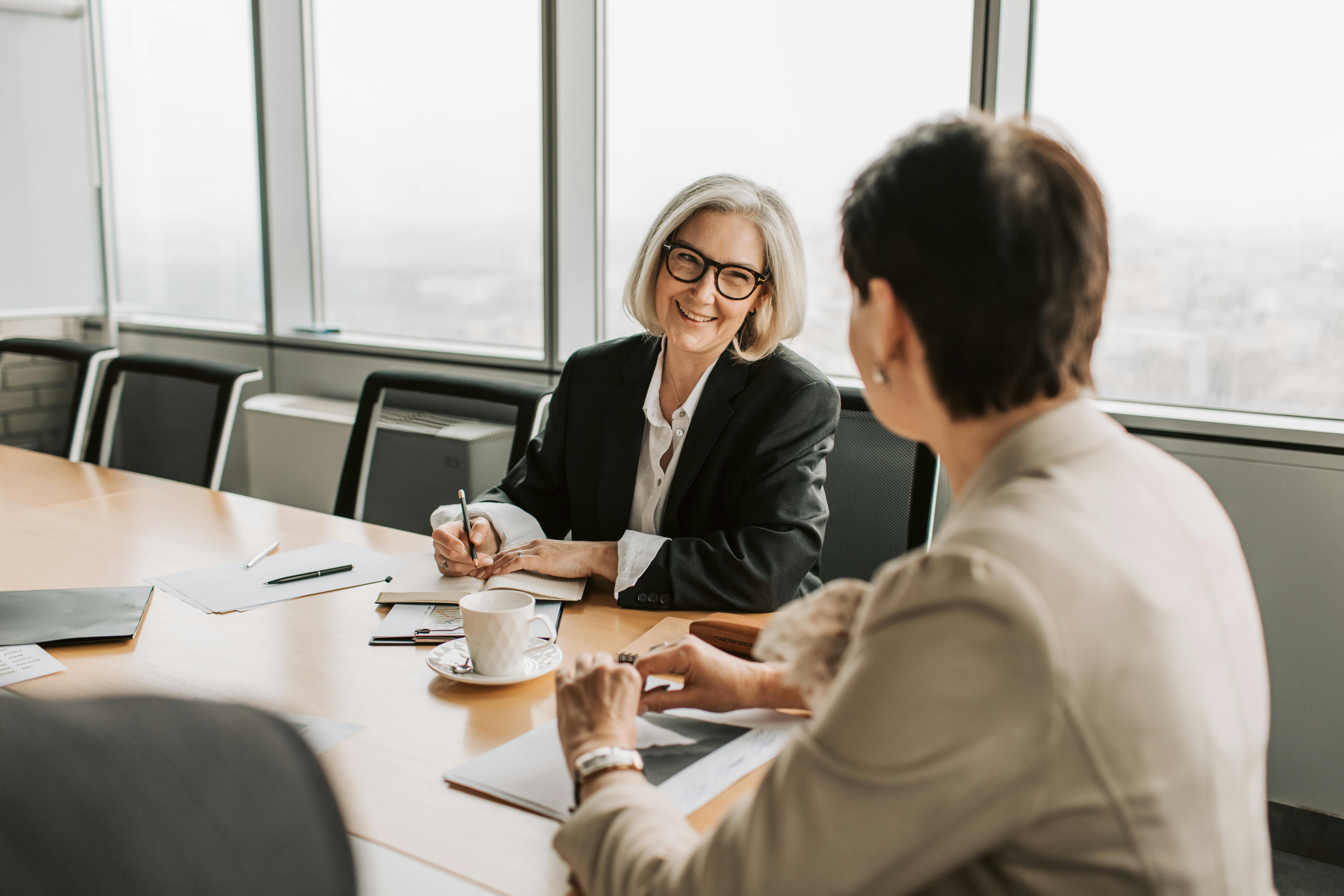 women smiling in meeting